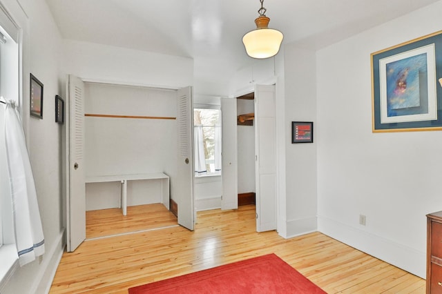 hall with hardwood / wood-style floors