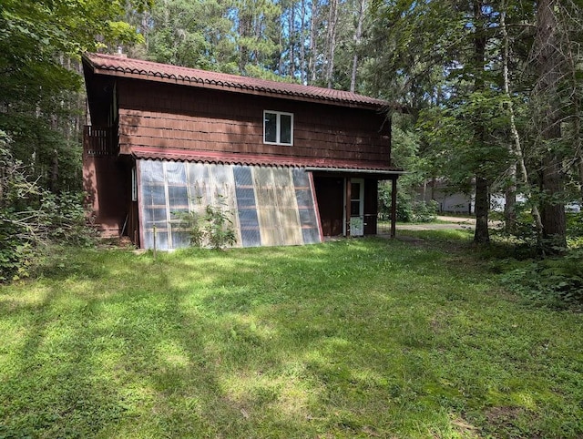 view of outbuilding with a yard