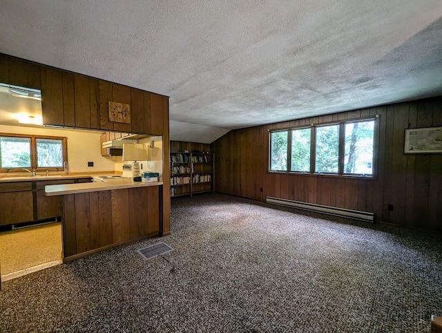 kitchen with dark carpet, a baseboard radiator, and a textured ceiling