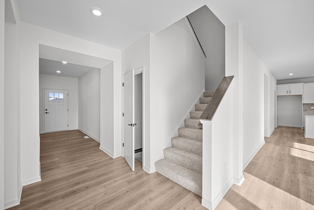 stairway with hardwood / wood-style floors