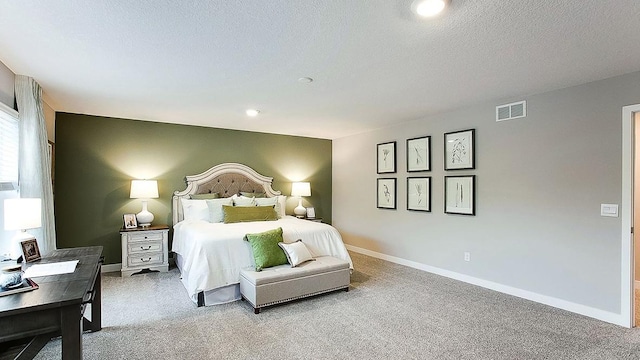 carpeted bedroom featuring a textured ceiling