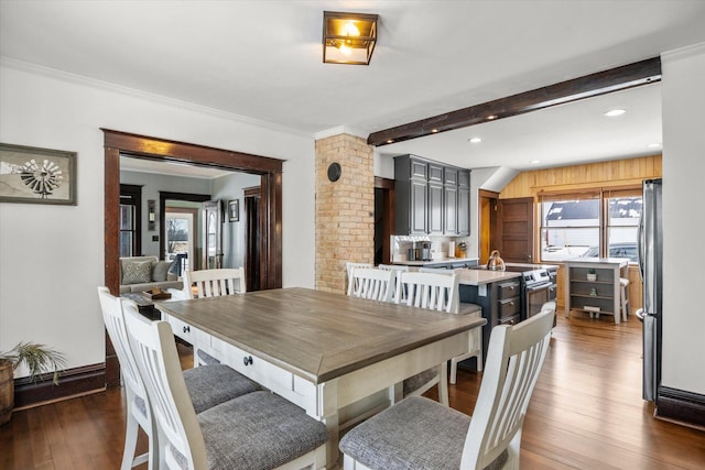 dining space featuring baseboards, wood finished floors, beamed ceiling, and recessed lighting
