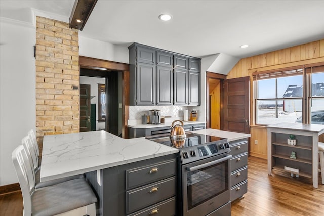 kitchen featuring open shelves, stainless steel electric range, backsplash, and light wood-style floors