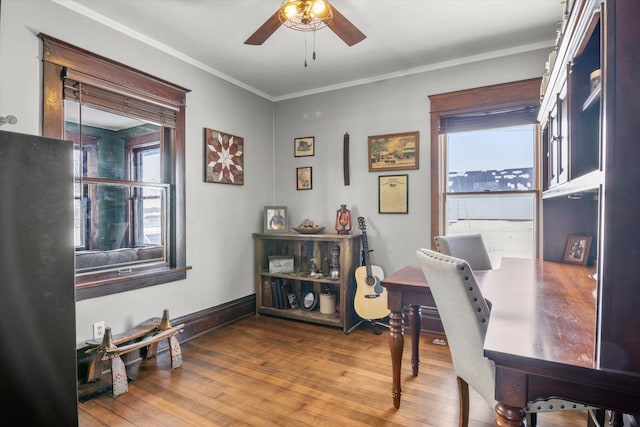 office area featuring ornamental molding, wood finished floors, a wealth of natural light, and ceiling fan