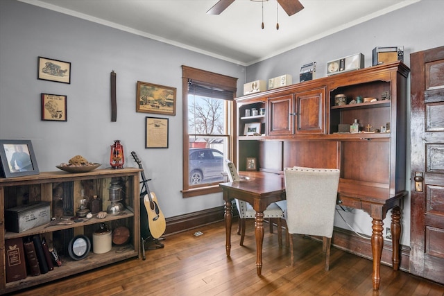 home office with wood finished floors, a ceiling fan, baseboards, and ornamental molding