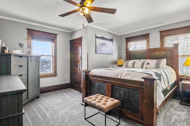 bedroom with crown molding, carpet flooring, baseboards, and ceiling fan