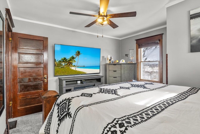 bedroom featuring carpet flooring, visible vents, crown molding, and a ceiling fan