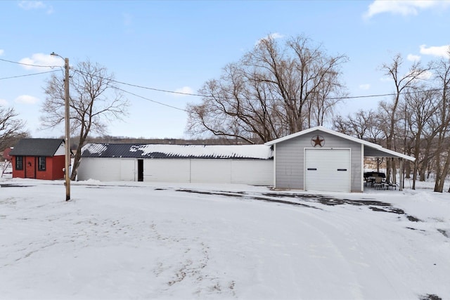 snow covered structure featuring an outdoor structure