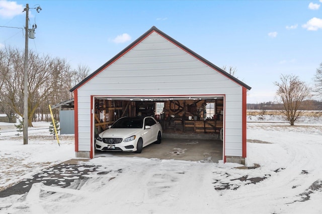 snow covered garage with a garage