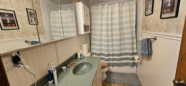 bathroom featuring vanity, toilet, and a shower with shower curtain