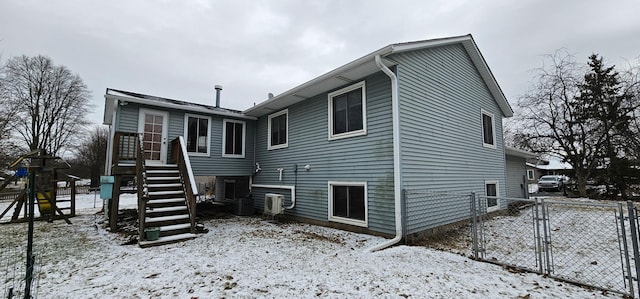 view of snow covered back of property