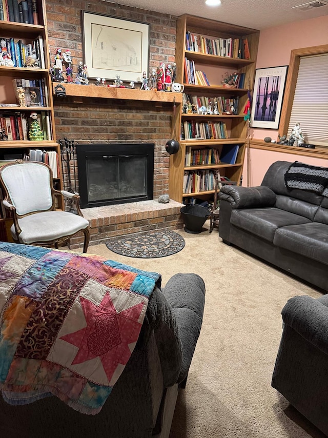 living room with a brick fireplace, a textured ceiling, and carpet flooring