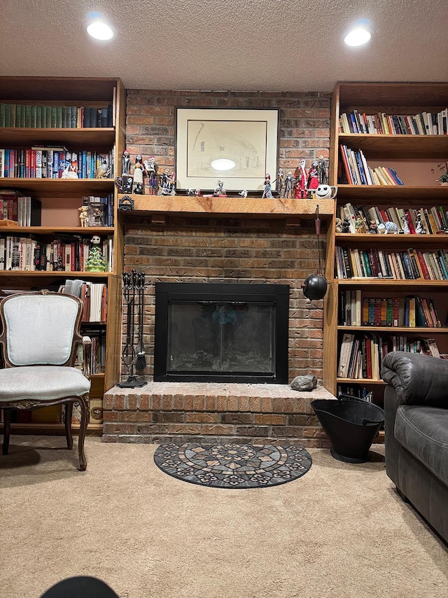 living area featuring a brick fireplace, carpet, and a textured ceiling