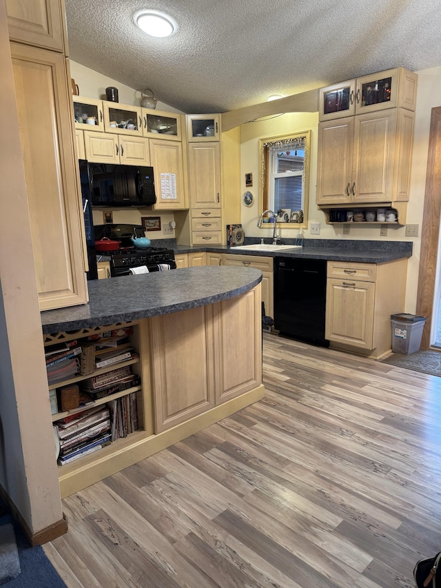 kitchen featuring sink, light hardwood / wood-style flooring, black appliances, a textured ceiling, and kitchen peninsula