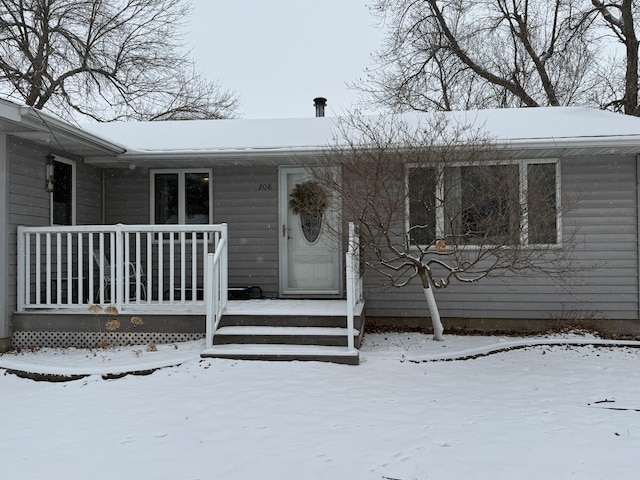 view of snow covered property entrance