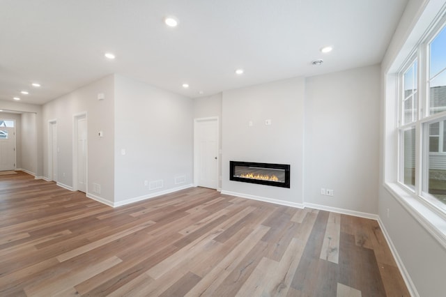 unfurnished living room with light hardwood / wood-style flooring