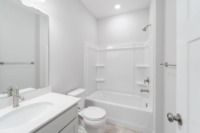 full bathroom with vanity, washtub / shower combination, and toilet