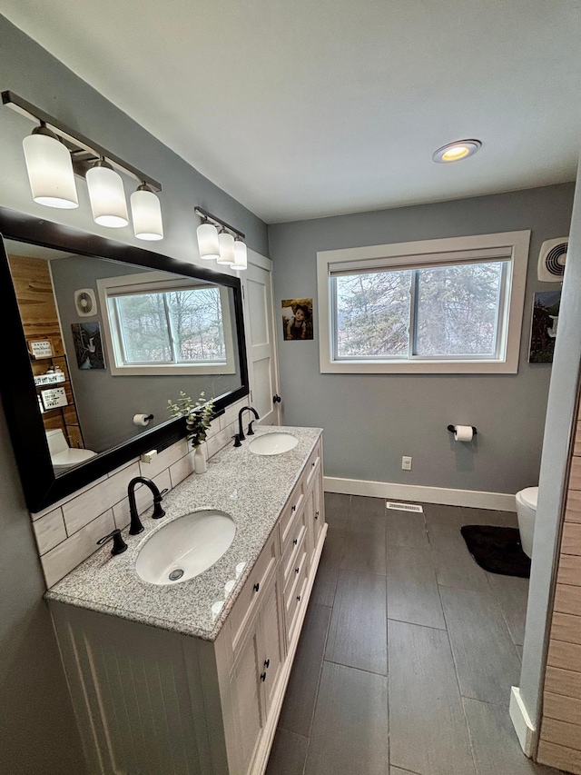 bathroom with vanity, hardwood / wood-style floors, and toilet