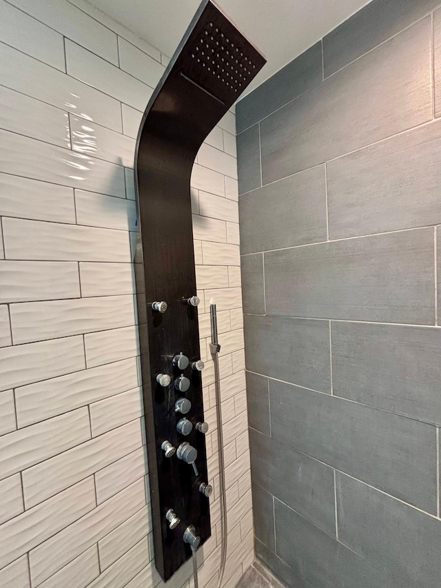 interior details with a tile shower