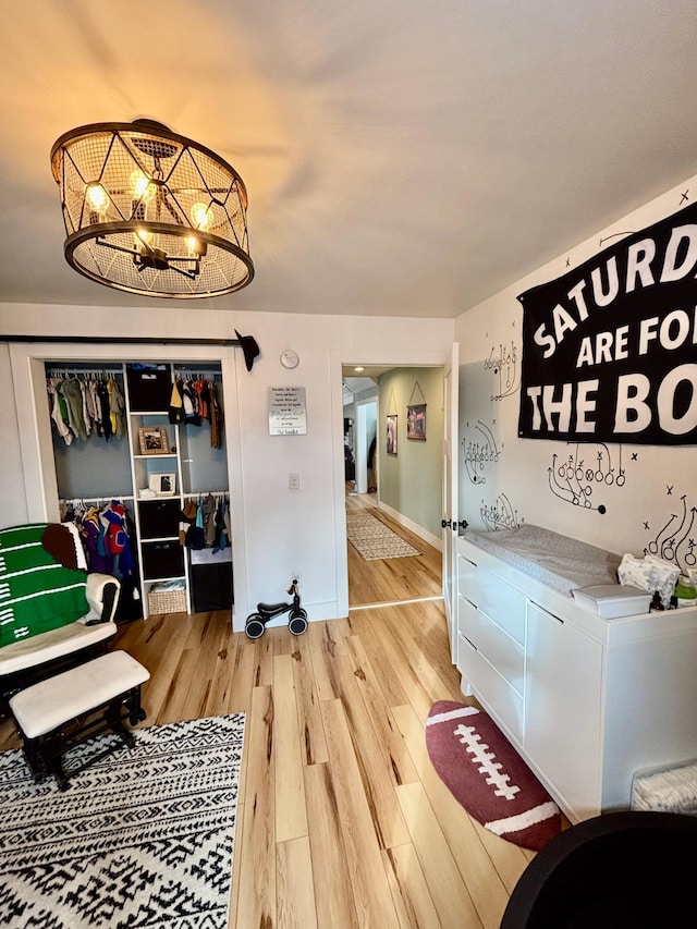 interior space with wood-type flooring and an inviting chandelier