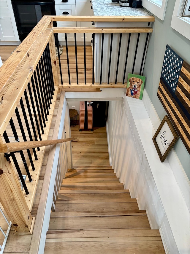 stairway with hardwood / wood-style floors