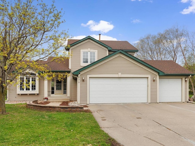 traditional home featuring an attached garage, a front lawn, roof with shingles, and concrete driveway