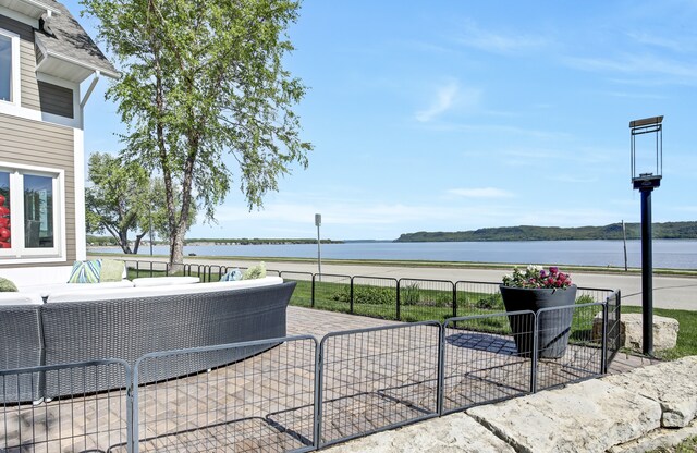 view of patio with an outdoor hangout area and a water view