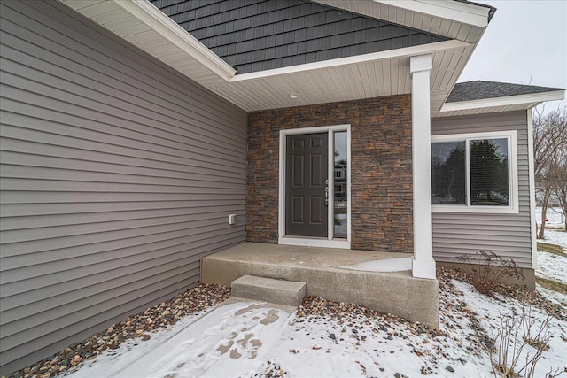 view of snow covered property entrance