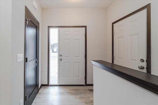 entryway featuring light hardwood / wood-style floors and a healthy amount of sunlight