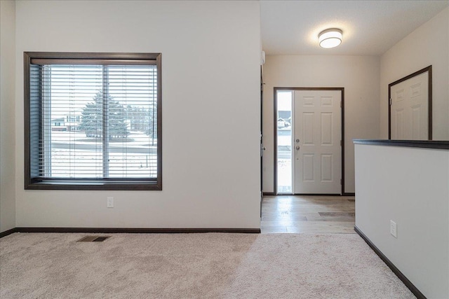 foyer with light colored carpet