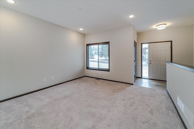 entrance foyer with light carpet