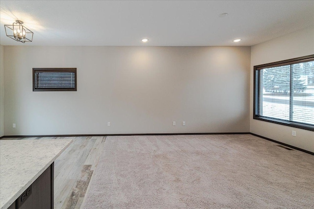 empty room featuring an inviting chandelier