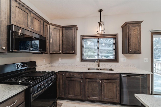 kitchen with stainless steel appliances, dark brown cabinets, sink, and light stone counters