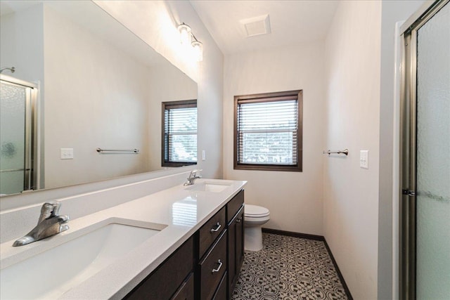 bathroom featuring an enclosed shower, vanity, and toilet