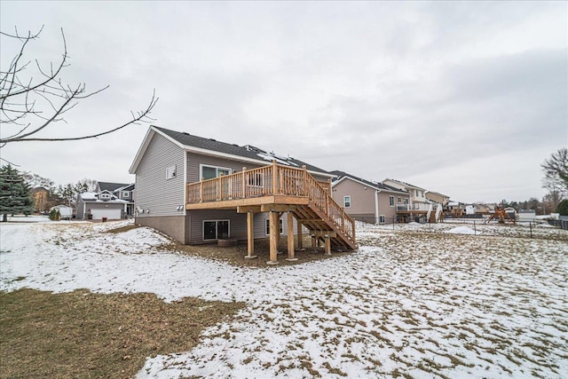 snow covered rear of property featuring a deck