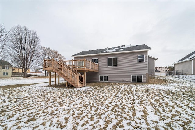 snow covered property with a wooden deck