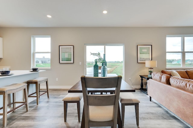 dining room with plenty of natural light, light wood-style flooring, and recessed lighting