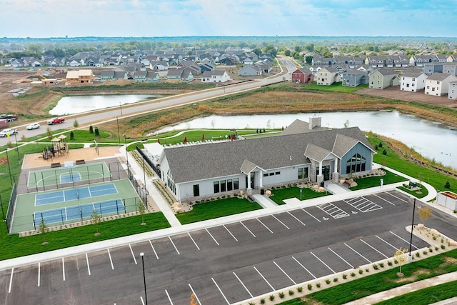 drone / aerial view featuring a water view and a residential view