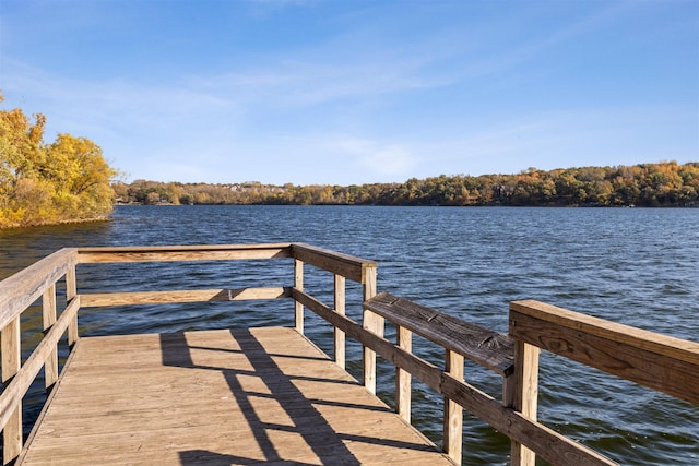 view of dock featuring a water view and a view of trees