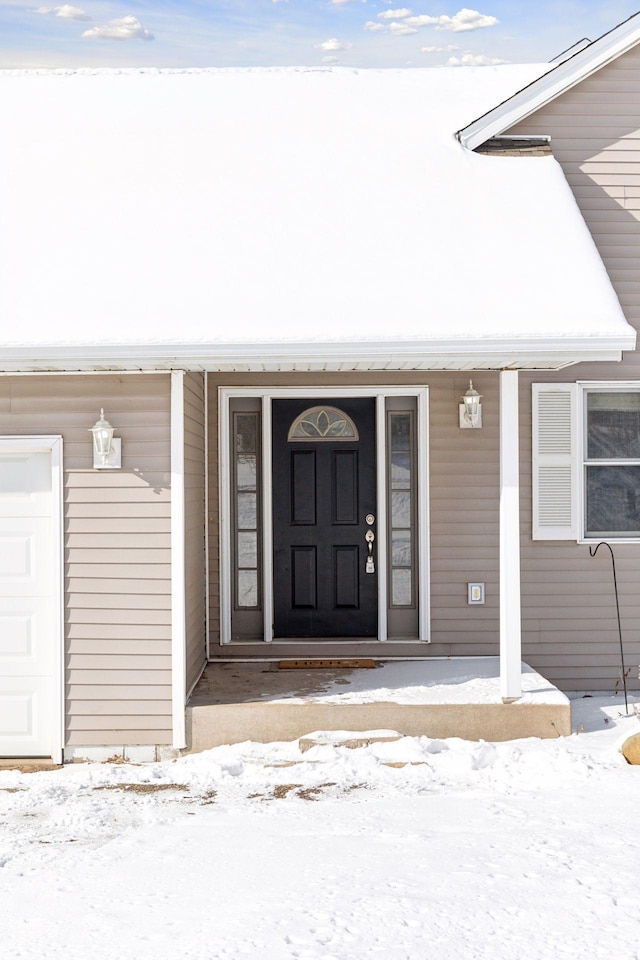 view of snow covered property entrance