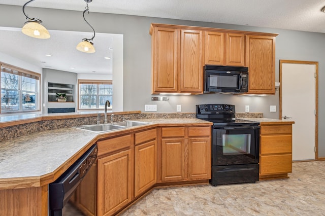 kitchen featuring a textured ceiling, sink, hanging light fixtures, and black appliances