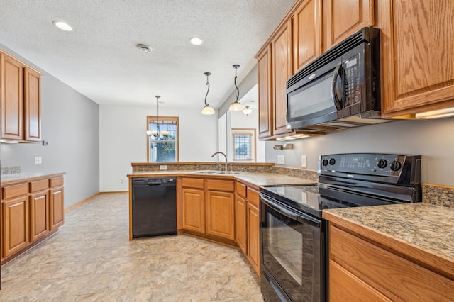 kitchen with pendant lighting, black appliances, sink, kitchen peninsula, and a textured ceiling