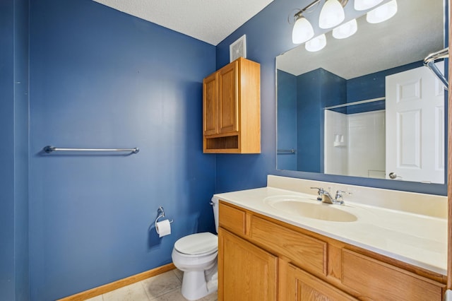 bathroom with walk in shower, toilet, a textured ceiling, vanity, and tile patterned flooring