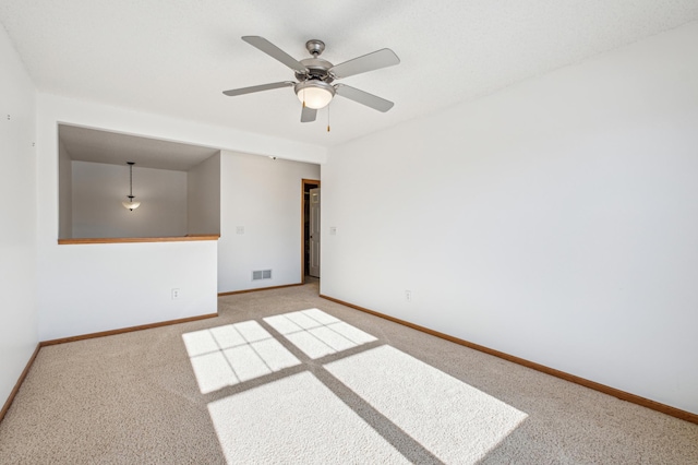 spare room featuring ceiling fan and carpet flooring