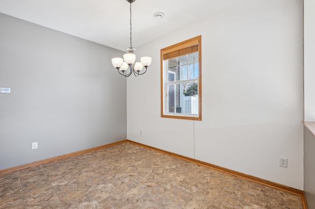 empty room featuring a notable chandelier