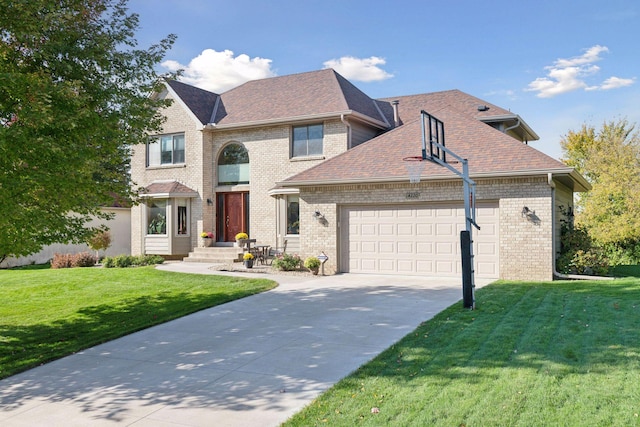 view of front of home with a shingled roof, brick siding, driveway, a garage, and a front yard