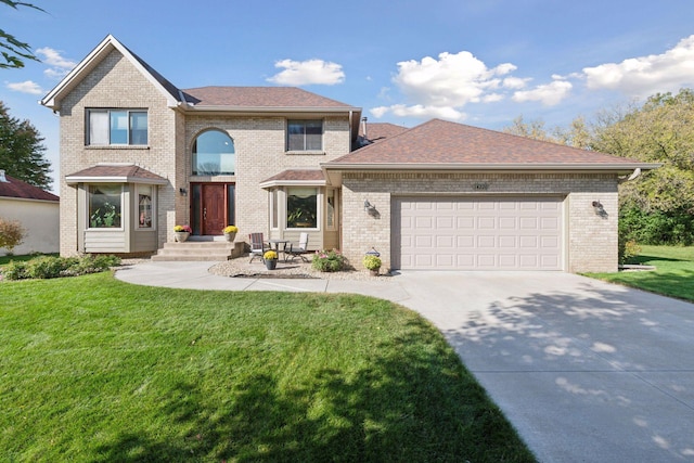 traditional-style home with driveway, a front lawn, an attached garage, and brick siding