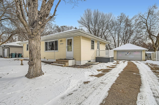 view of front of property featuring a garage and an outdoor structure