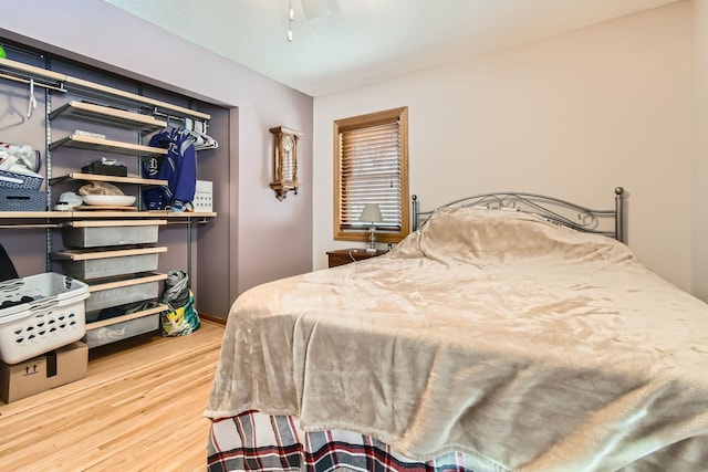 bedroom with ceiling fan and wood-type flooring