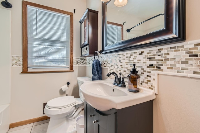 bathroom featuring tile patterned flooring, vanity, backsplash, and toilet